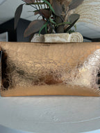 Metallic rose gold clutch