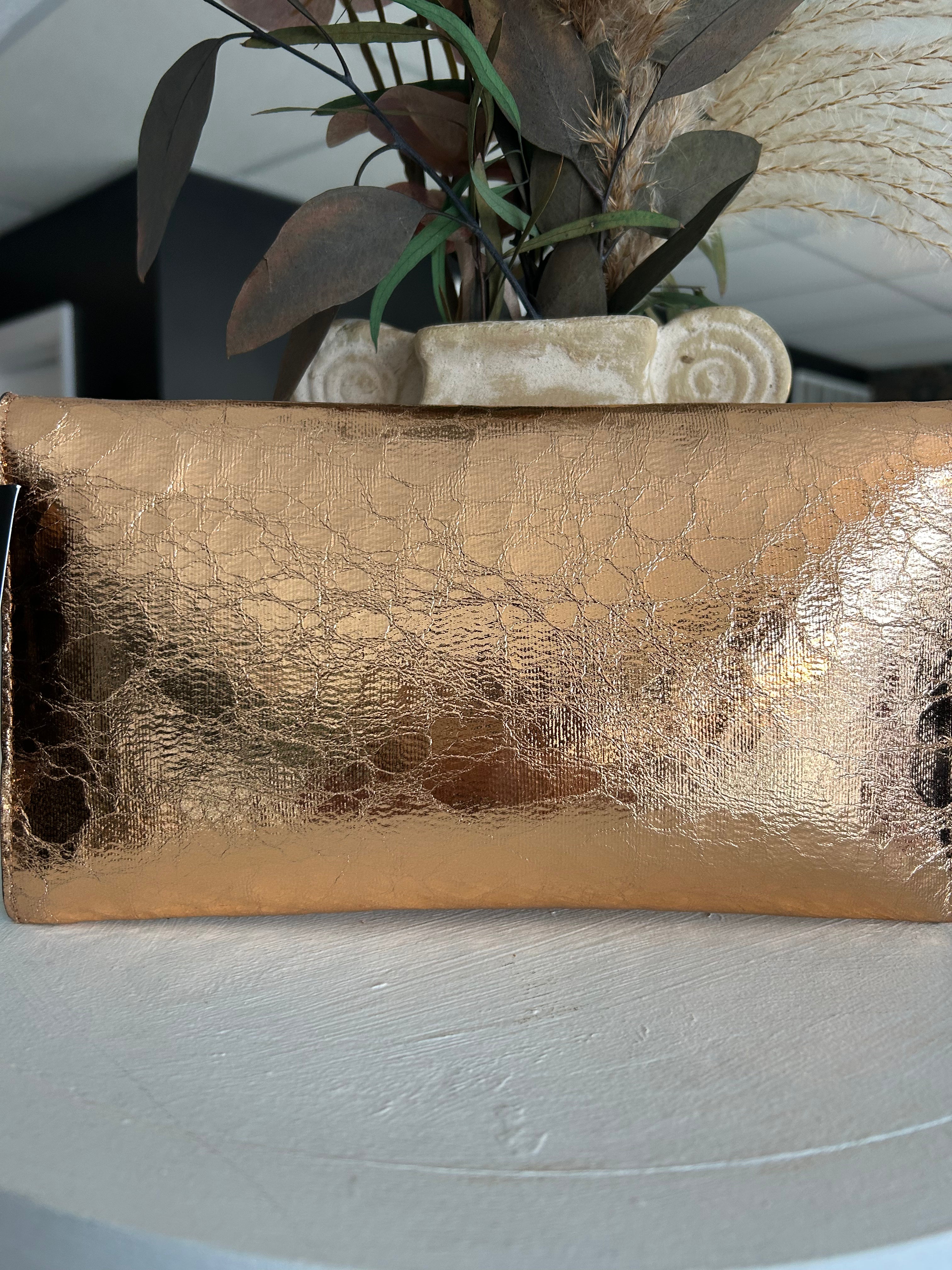Metallic rose gold clutch